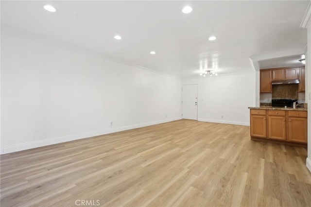 unfurnished living room with light wood-type flooring, crown molding, baseboards, and recessed lighting