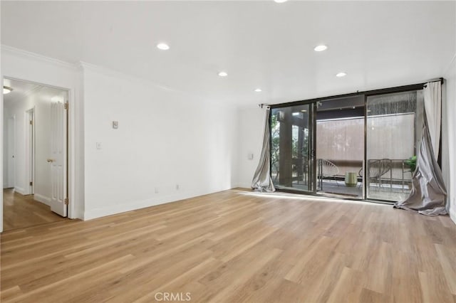 unfurnished room with recessed lighting, crown molding, baseboards, and wood finished floors