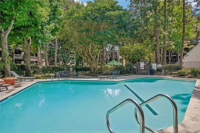 pool featuring a patio area and fence