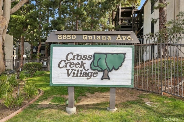 community / neighborhood sign with fence