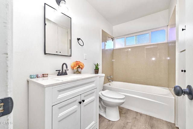 bathroom featuring shower / tub combination, vanity, toilet, and wood finished floors