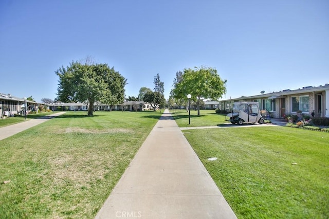 view of home's community with a yard