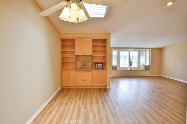 unfurnished living room featuring lofted ceiling, light wood-style floors, baseboards, a ceiling fan, and built in features