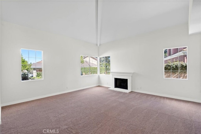 unfurnished living room with high vaulted ceiling, a fireplace, baseboards, and carpet flooring