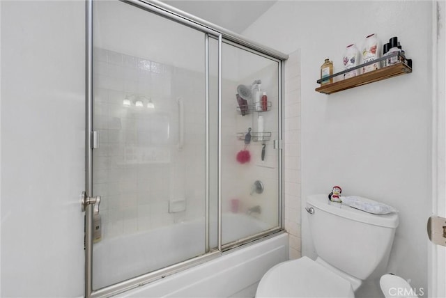 full bathroom featuring enclosed tub / shower combo and toilet