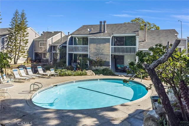 community pool featuring a patio area