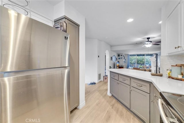 kitchen with visible vents, light countertops, gray cabinets, appliances with stainless steel finishes, and arched walkways