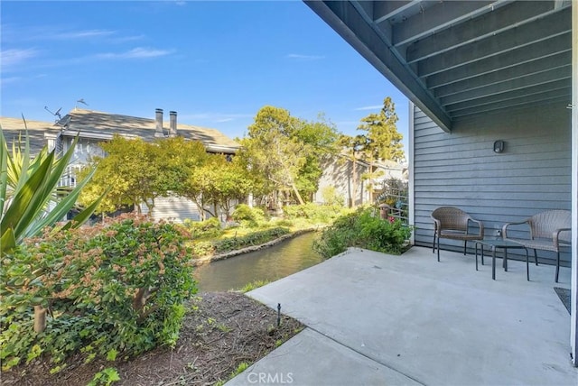 view of patio with a water view