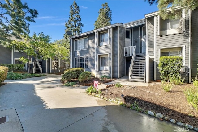 view of front of property with stairway and driveway