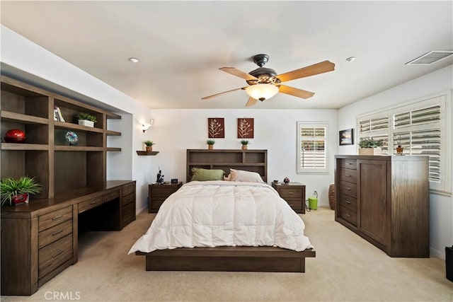 bedroom with visible vents, light carpet, and a ceiling fan