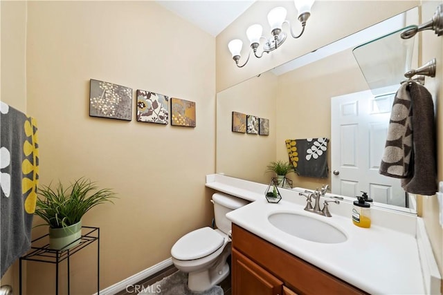 half bath with toilet, vanity, and baseboards