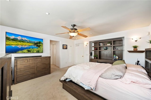 bedroom featuring a ceiling fan and light colored carpet