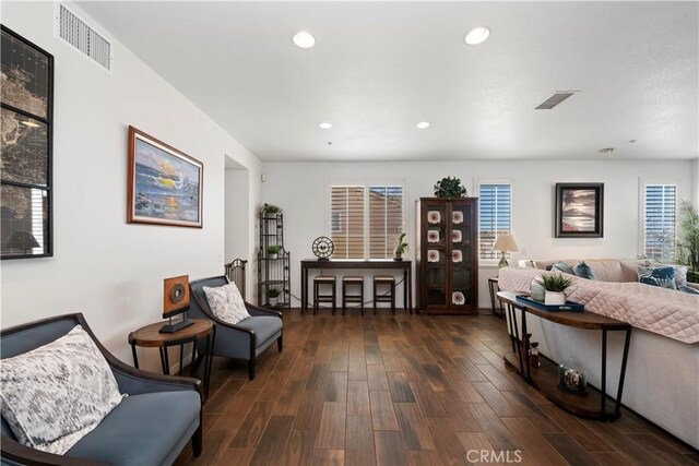 sitting room with visible vents, recessed lighting, and dark wood-type flooring