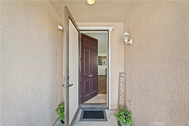 property entrance with stucco siding