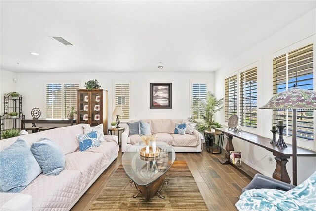 living area featuring wood finish floors, visible vents, and recessed lighting