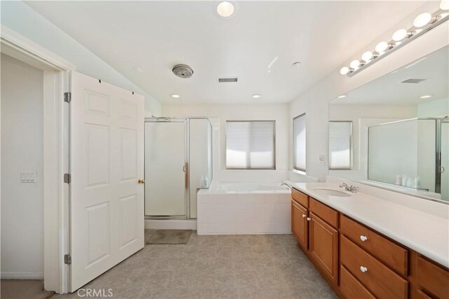 bathroom with a bath, visible vents, a stall shower, and vanity