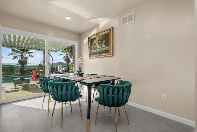 tiled dining room featuring recessed lighting, visible vents, and baseboards