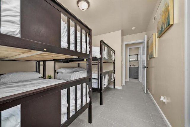 tiled bedroom featuring baseboards