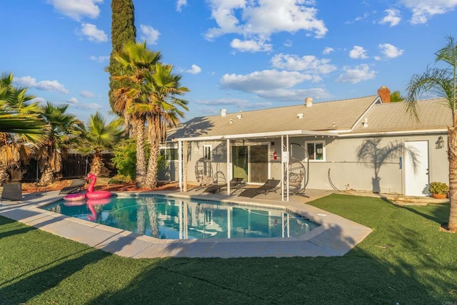 view of pool with a yard, a fenced in pool, a fenced backyard, and a patio