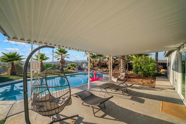 outdoor pool with a patio area