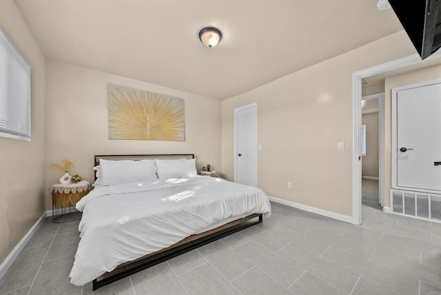 tiled bedroom featuring visible vents and baseboards