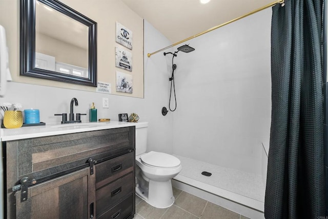 full bath with a tile shower, toilet, tile patterned flooring, and vanity