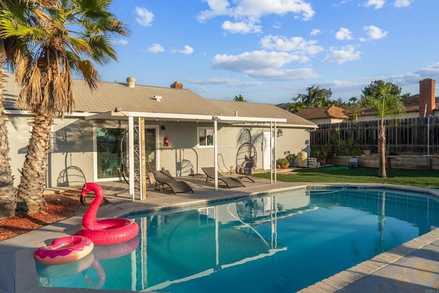 view of swimming pool with a patio, fence, and a fenced in pool