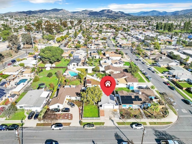 birds eye view of property featuring a mountain view and a residential view