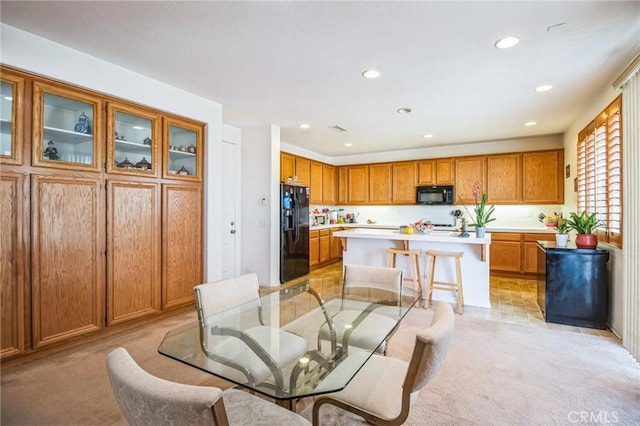 dining space featuring light carpet and recessed lighting