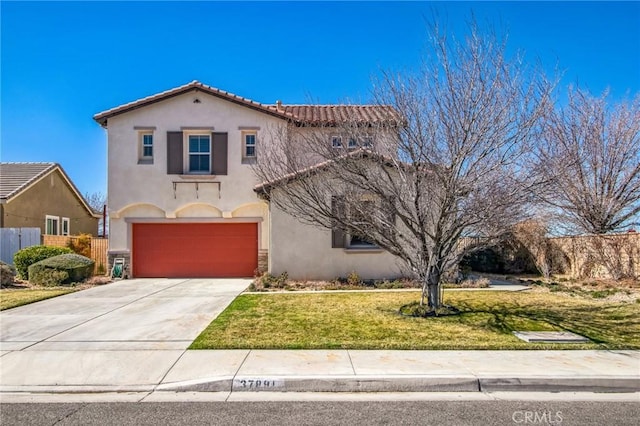 mediterranean / spanish house featuring a front yard, stucco siding, driveway, stone siding, and an attached garage