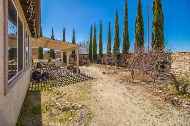 view of yard featuring a patio area, a fenced backyard, and a pergola