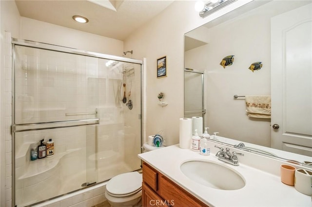 full bathroom featuring vanity, toilet, and a stall shower