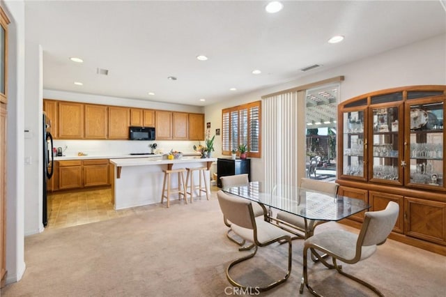 dining room featuring recessed lighting, visible vents, and light colored carpet