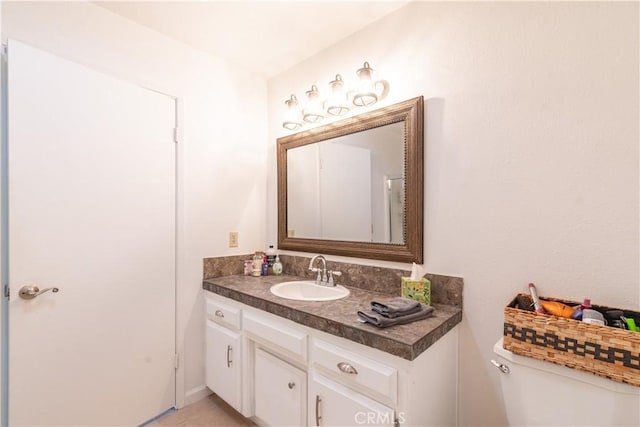 bathroom featuring toilet and vanity