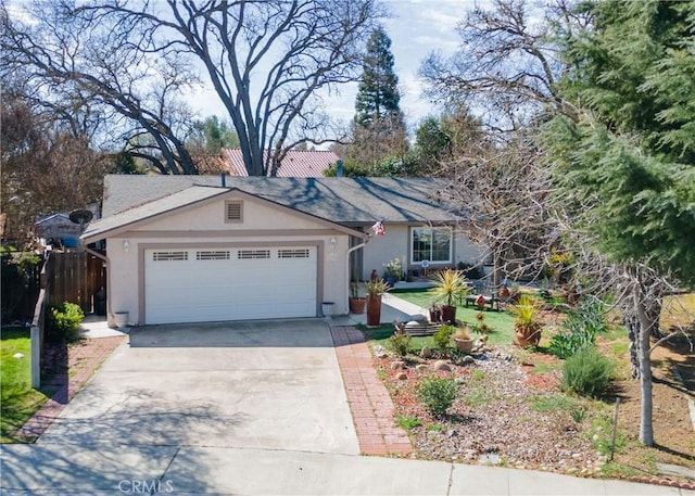 single story home with concrete driveway, an attached garage, fence, and stucco siding