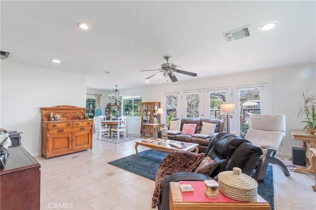 living area with recessed lighting, visible vents, baseboards, and ceiling fan with notable chandelier