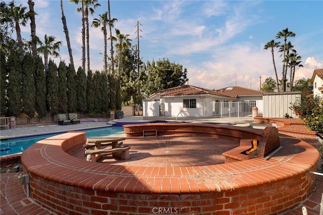 outdoor pool with a patio area and fence