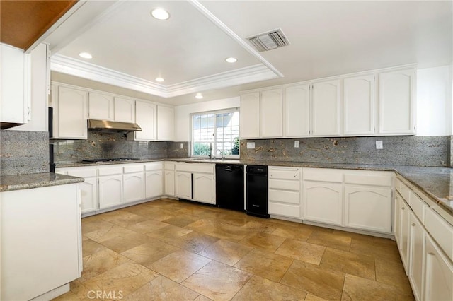 kitchen featuring under cabinet range hood, visible vents, black dishwasher, tasteful backsplash, and a raised ceiling