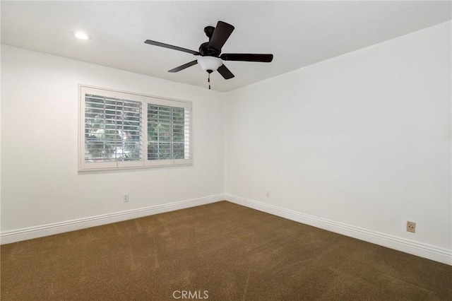 empty room featuring baseboards, dark colored carpet, a ceiling fan, and recessed lighting