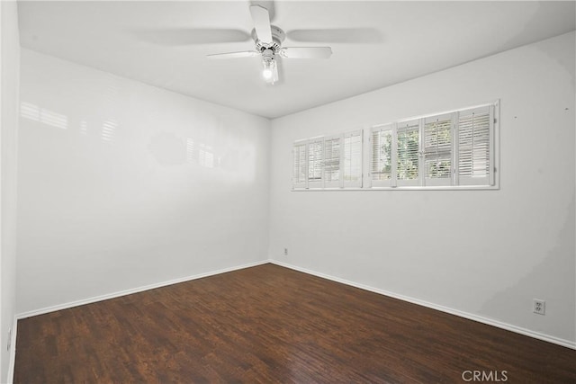 unfurnished room featuring a ceiling fan, baseboards, and wood finished floors