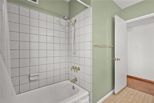 full bathroom with baseboards and shower / tub combo with curtain