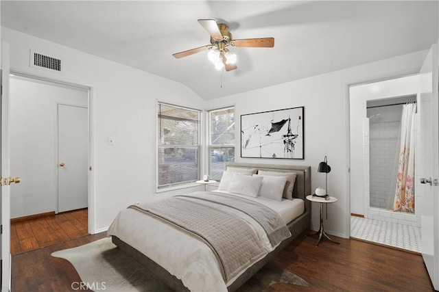 bedroom with lofted ceiling, ceiling fan, hardwood / wood-style flooring, visible vents, and baseboards