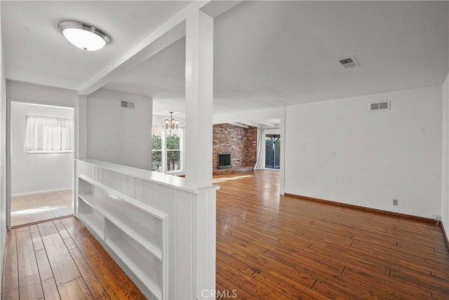 corridor featuring hardwood / wood-style floors and visible vents