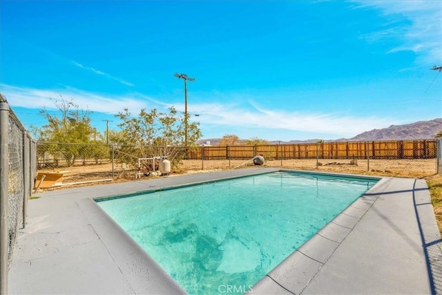 view of pool with a fenced backyard