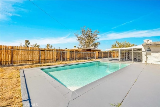 view of pool with a patio and a fenced backyard