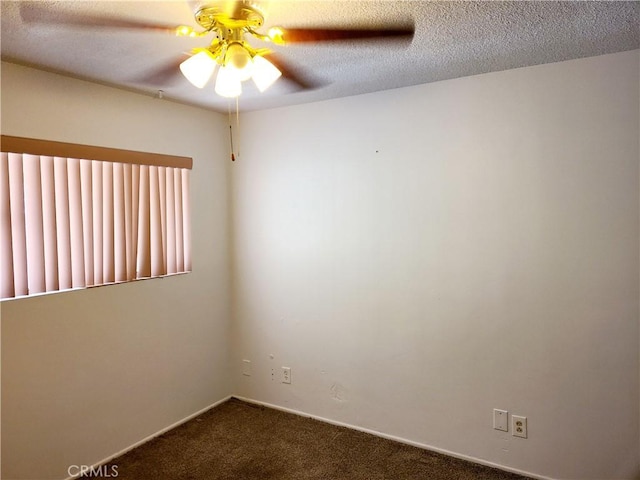 empty room with dark carpet, a textured ceiling, and a ceiling fan