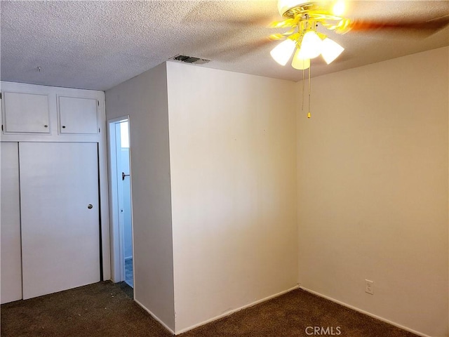 1311 E Olive St, Colton, CA 92324 - empty room with dark carpet, a textured ceiling, ceiling fan, and visible vents
