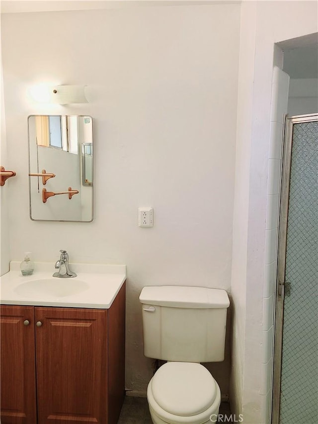 1311 E Olive St, Colton, CA 92324 - bathroom featuring vanity, a shower stall, and toilet