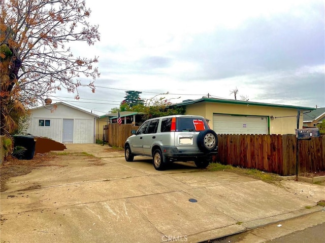 exterior space featuring fence and driveway