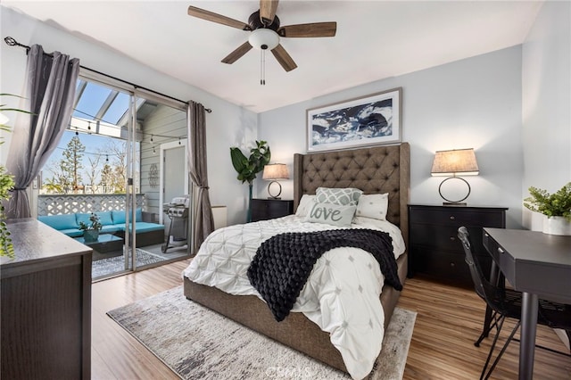 bedroom with access to outside, a ceiling fan, and wood finished floors